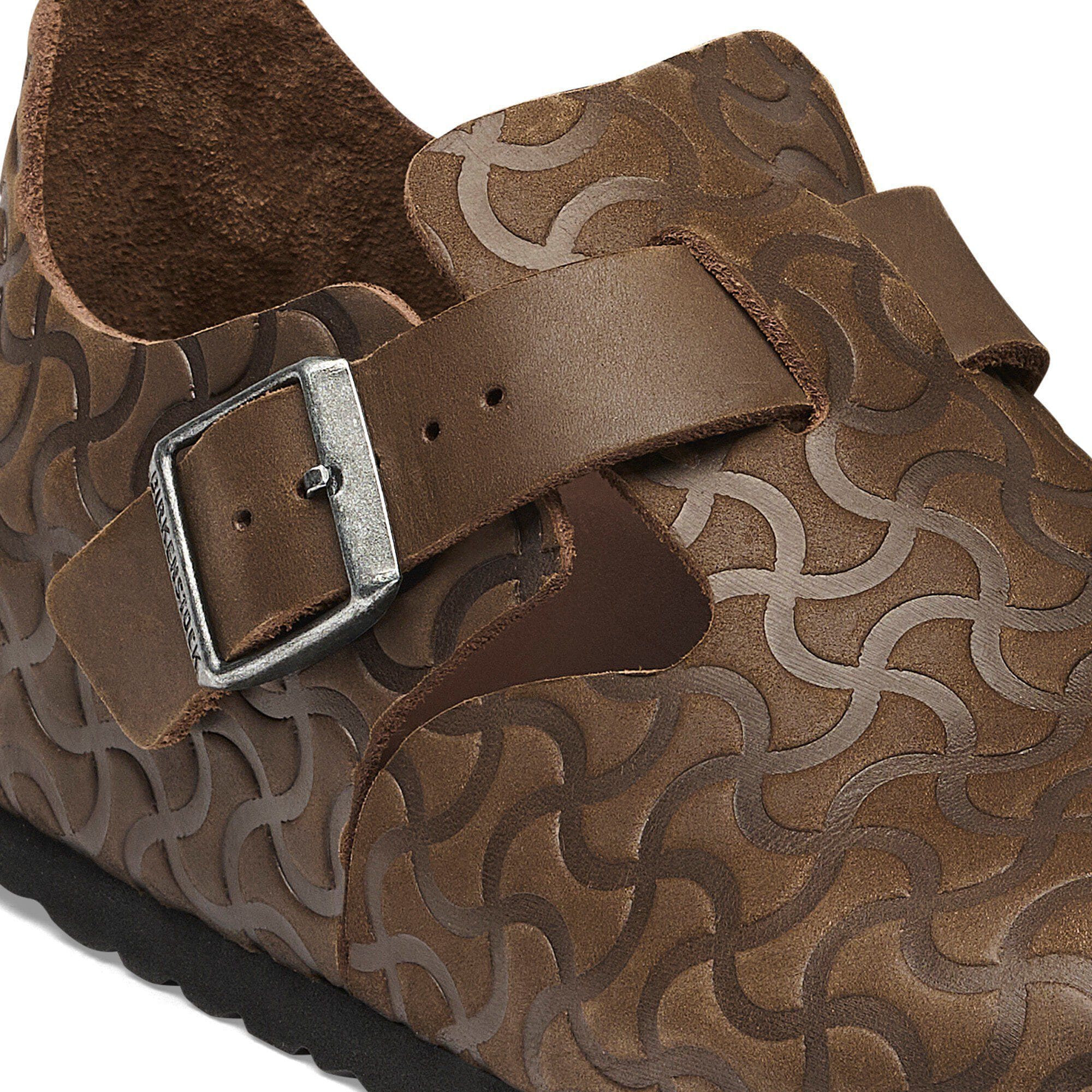 London Single Strap Natural Leather Embossed Close-up view showing material detail