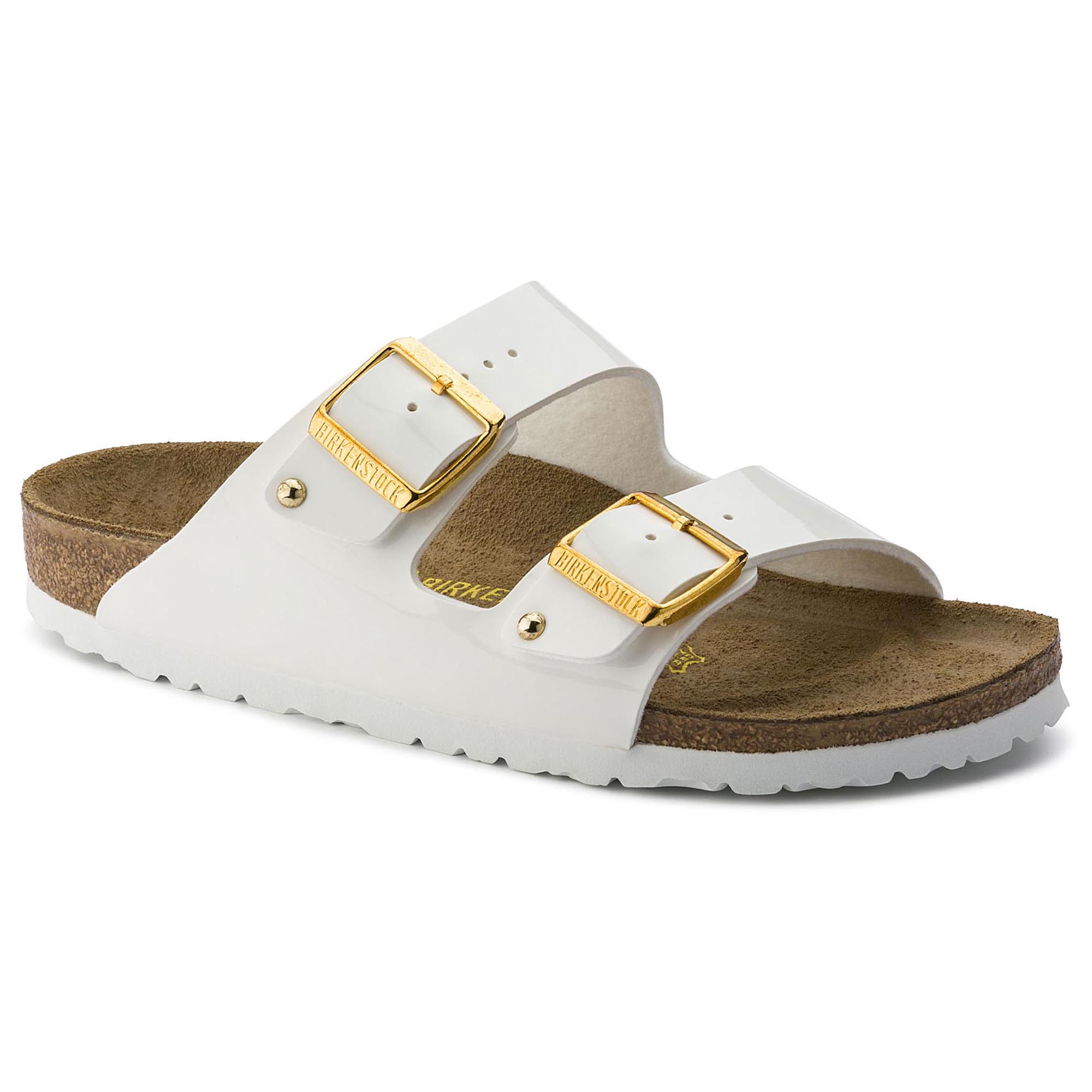 white birkenstocks with gold buckles