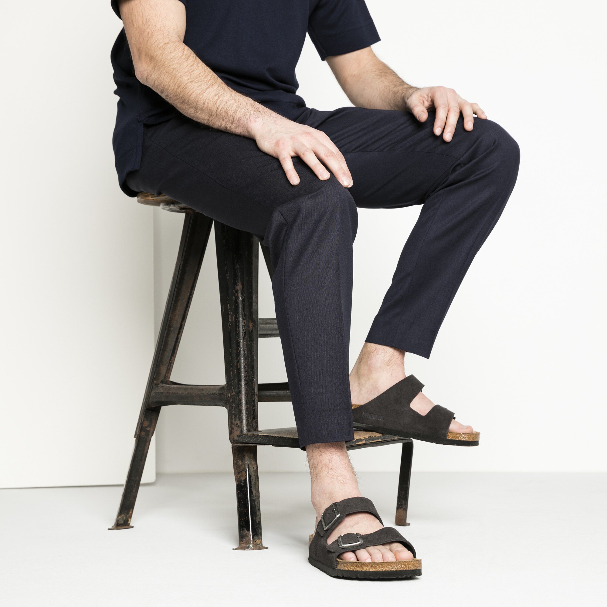 Men's Birkenstocks worn with slacks and a t-shirt.