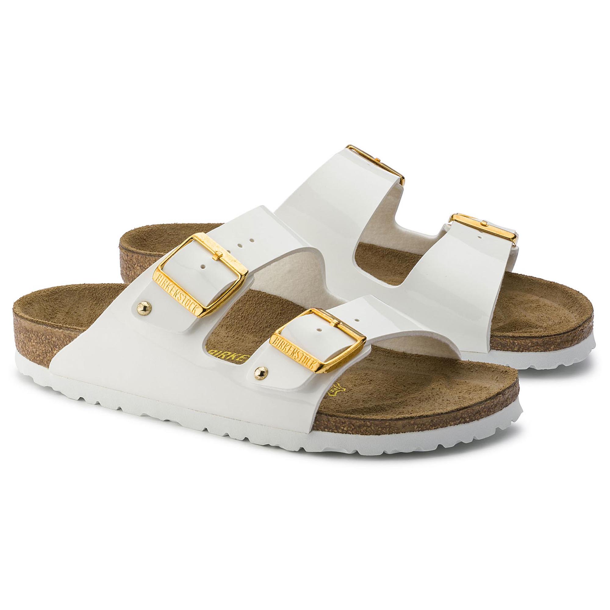 white birkenstocks with gold buckles